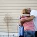 People embrace each other after a house caught fire. Daniel Brenner I AnnArbor.com